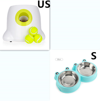 Automatic dog ball launcher with tennis balls and blue dog bowls for interactive dog toys.
