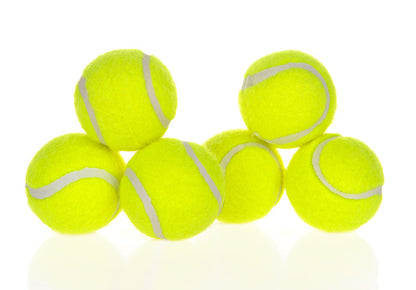 A group of bright yellow tennis balls stacked for use with interactive dog toys.