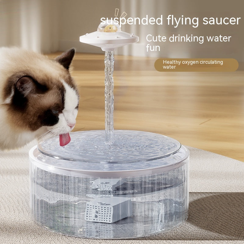 Cat drinking from AquaFlow suspended flying saucer pet water fountain with circulating water stream