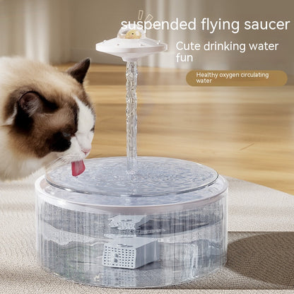 Cat drinking from AquaFlow suspended flying saucer pet water fountain with circulating water stream
