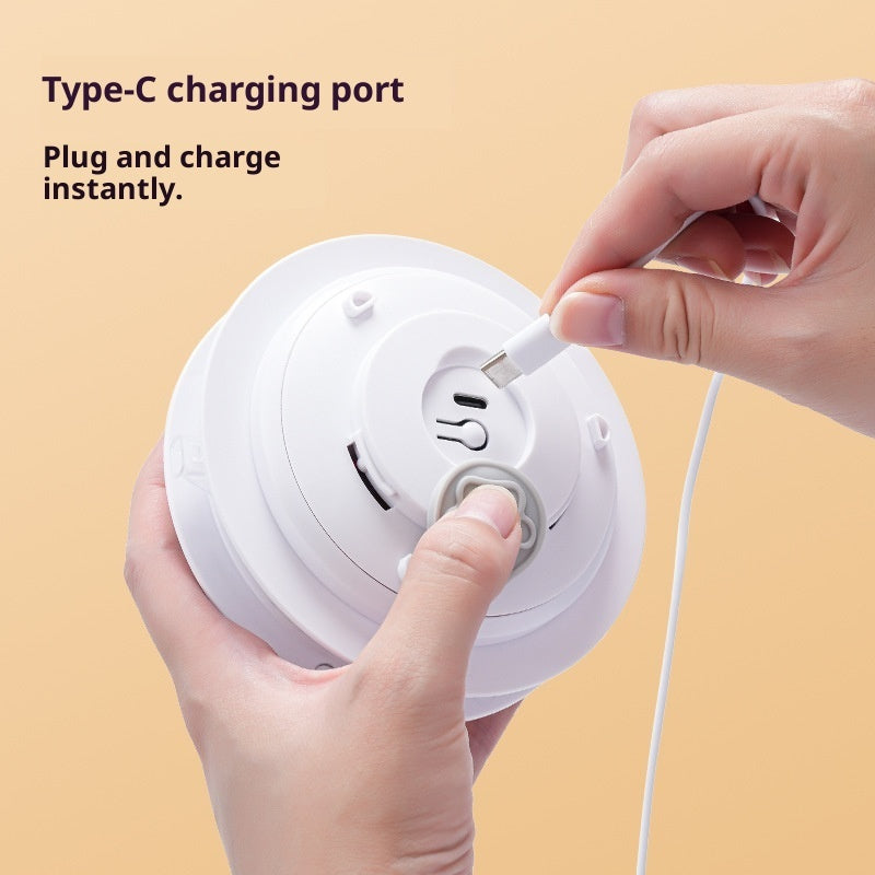 Close up of a hand plugging a Type C cable into the Peekaboo TM rechargeable smart motorized core
